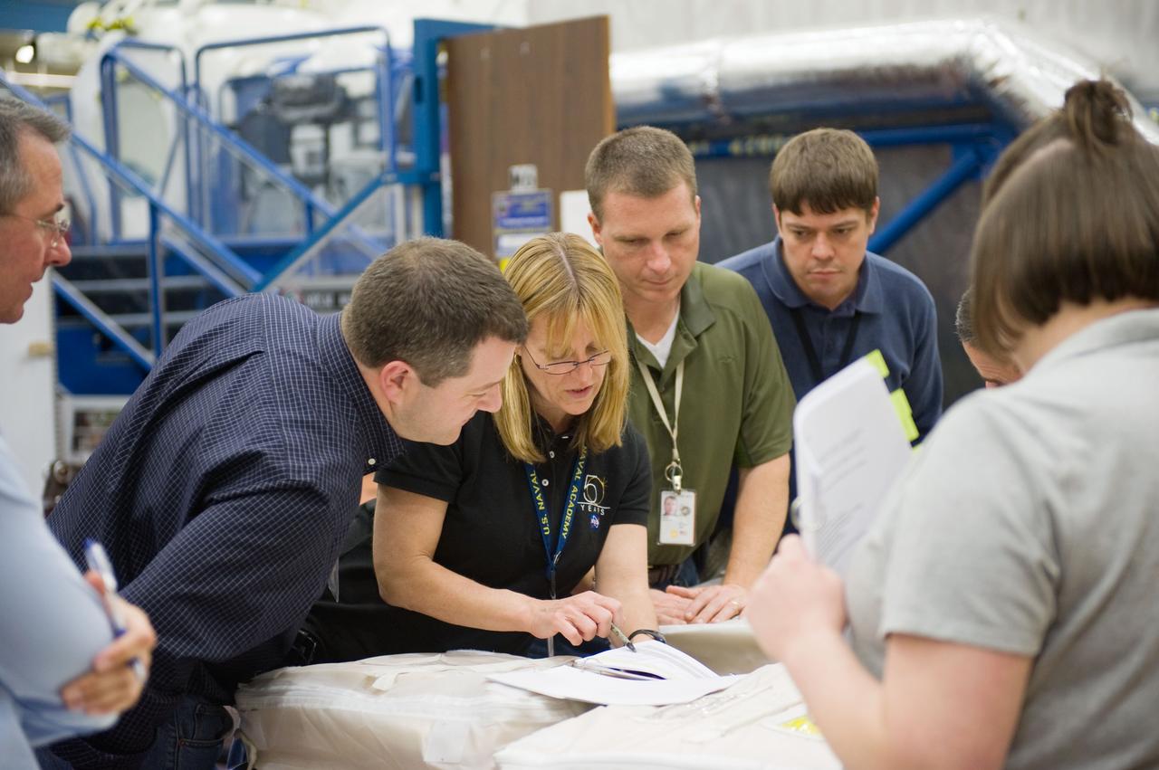 JSC2009-E-258402 (8 Dec. 2009) --- Astronaut Terry Virts (second right), STS-130 pilot; along with astronauts Kathryn Hire, Nicholas Patrick (left) and Robert Behnken, all mission specialists, participate in a training session in the Space Vehicle Mock-up Facility at NASA's Johnson Space Center.