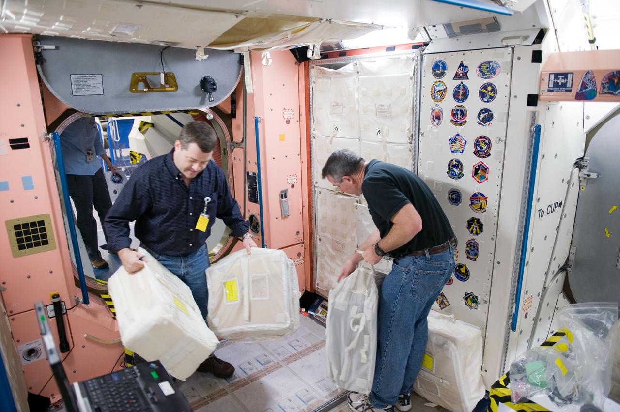 JSC2009-E-258418 (8 Dec. 2009) --- Astronauts Stephen Robinson (right) and Nicholas Patrick, both STS-130 mission specialists, participate in a training session in an International Space Station mock-up/trainer in the Space Vehicle Mock-up Facility at NASA's Johnson Space Center.
