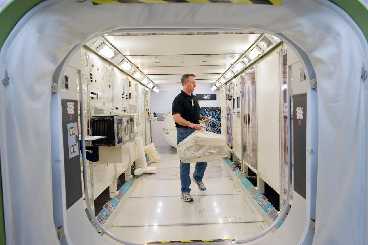 JSC2009-E-258423 (8 Dec. 2009) --- Astronaut Stephen Robinson, STS-130 mission specialist, participates in a training session in an International Space Station mock-up/trainer in the Space Vehicle Mock-up Facility at NASA's Johnson Space Center.