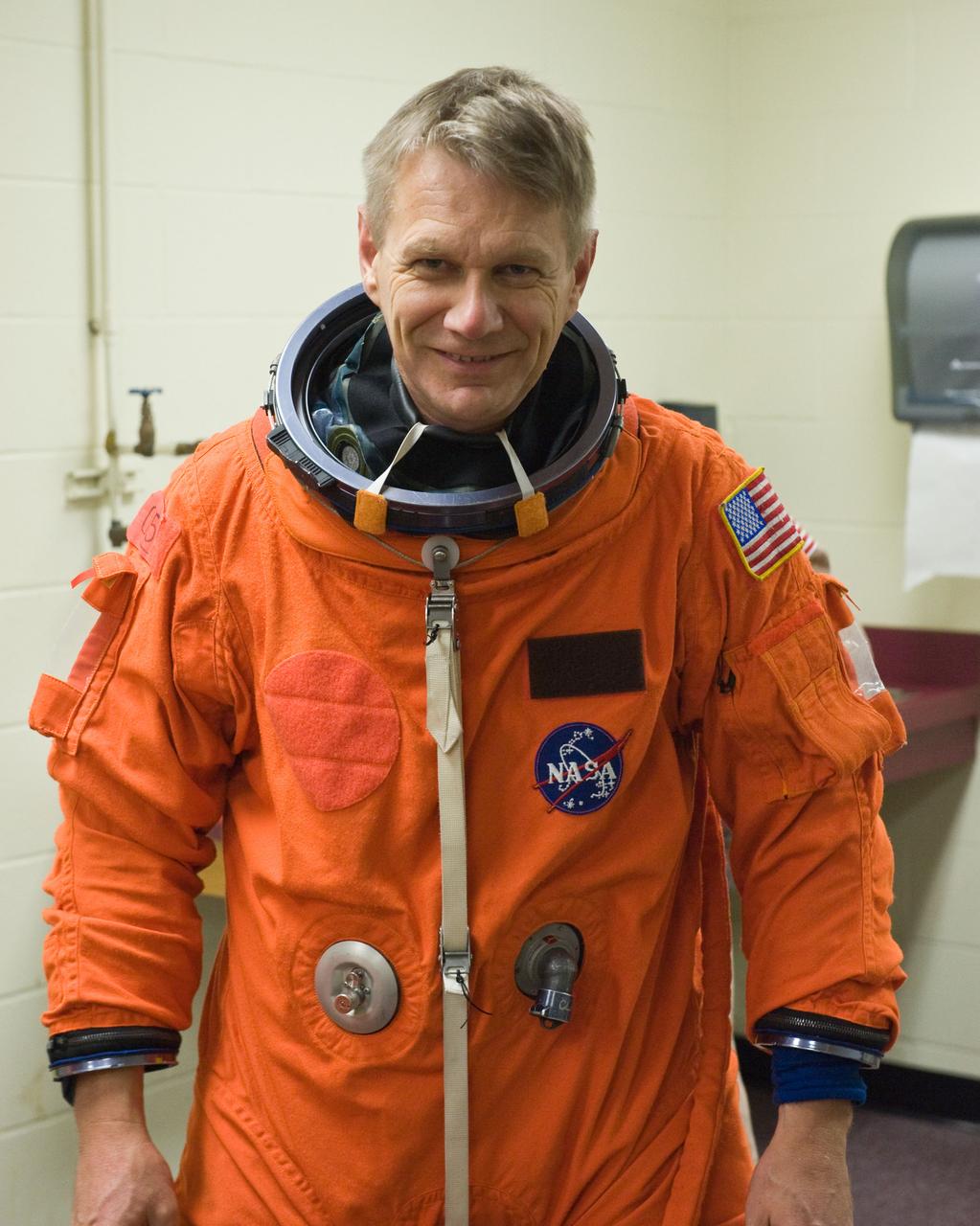 JSC2009-E-258451 (8 Dec. 2009) --- Astronaut Piers Sellers, STS-132 mission specialist, attired in a training version of his shuttle launch and entry suit, awaits the start of a training session in the Space Vehicle Mock-up Facility at NASA's Johnson Space Center.