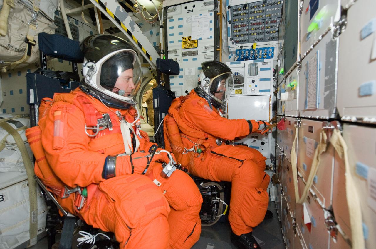 JSC2009-E-258484 (8 Dec. 2009) --- Attired in training versions of their shuttle launch and entry suits, astronauts Garrett Reisman (foreground) and Steve Bowen, both STS-132 mission specialists, participate in a training session on the middeck of the crew compartment trainer (CCT-2) in the Space Vehicle Mockup Facility at NASA?s Johnson Space Center.