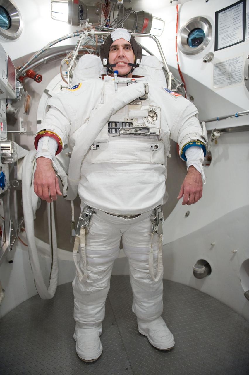 JSC2009-E-285099 (16 Dec. 2009) --- Astronaut Rick Mastracchio, STS-131 mission specialist, participates in an Extravehicular Mobility Unit (EMU) spacesuit fit check in the Space Station Airlock Test Article (SSATA) in the Crew Systems Laboratory at NASA's Johnson Space Center.