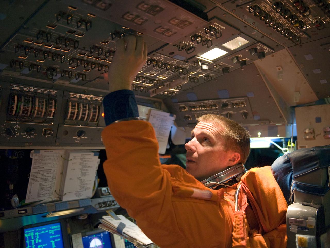 JSC2009-E-286655 (21 Dec. 2009) --- Astronaut Terry Virts, STS-130 pilot, attired in a training version of his shuttle launch and entry suit, occupies the pilot?s station during a training session in the Mission Simulation Development Facility at NASA's Johnson Space Center.
