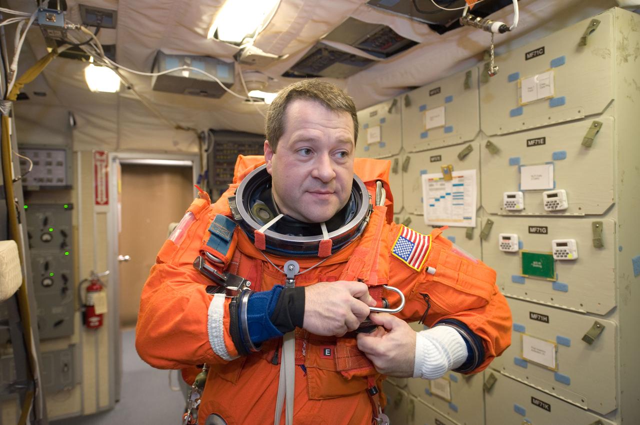 JSC2009-E-286664 (21 Dec. 2009) --- Astronaut Nicholas Patrick, STS-130 mission specialist, dons a training version of his shuttle launch and entry suit in preparation for a training session in the Mission Simulation Development Facility at NASA's Johnson Space Center.