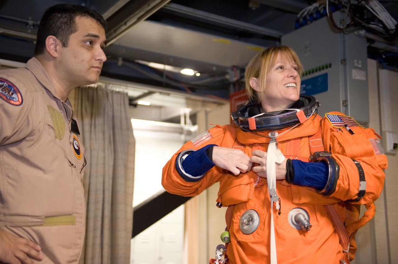JSC2009-E-286666 (21 Dec. 2009) --- Astronaut Kathryn Hire, STS-130 mission specialist, dons a training version of her shuttle launch and entry suit in preparation for a training session in the Mission Simulation Development Facility at NASA's Johnson Space Center.