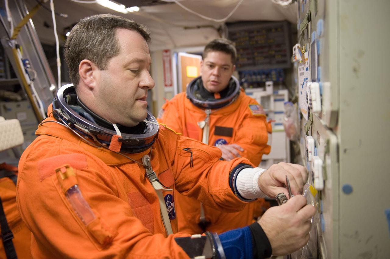 JSC2009-E-286680 (21 Dec. 2009) --- Astronauts Nicholas Patrick (foreground) and Robert Behnken, both STS-130 mission specialists, attired in training versions of their shuttle launch and entry suits, participate in a training session in the Mission Simulation Development Facility at NASA's Johnson Space Center.