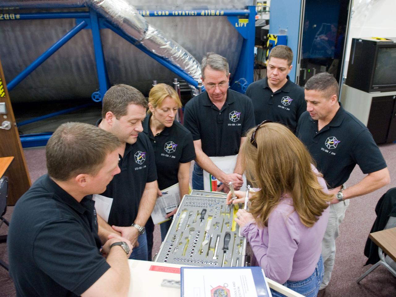 JSC2009-E-286841 (21 Dec. 2009) --- The STS-130 crew members participate in a training session in the Space Vehicle Mock-up Facility at NASA's Johnson Space Center. Pictured from the right are astronauts George Zamka, commander; Robert Behnken, Stephen Robinson, Kathryn Hire, Nicholas Patrick, all mission specialists; and Terry Virts, pilot.