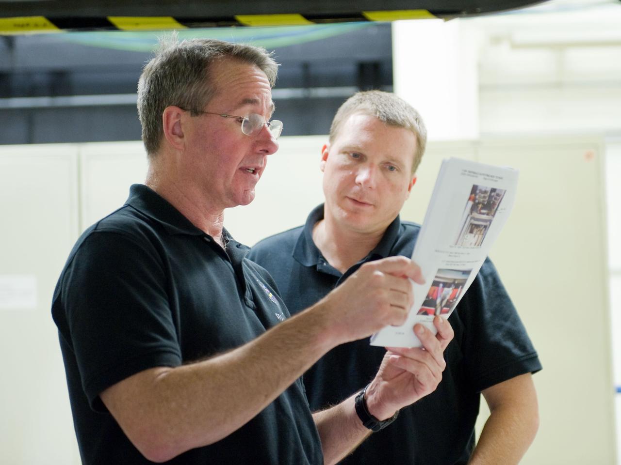 JSC2009-E-286843 (21 Dec. 2009) --- Astronauts Terry Virts (right), STS-130 pilot; and Stephen Robinson, mission specialist, participate in a training session in the Space Vehicle Mock-up Facility at NASA's Johnson Space Center.