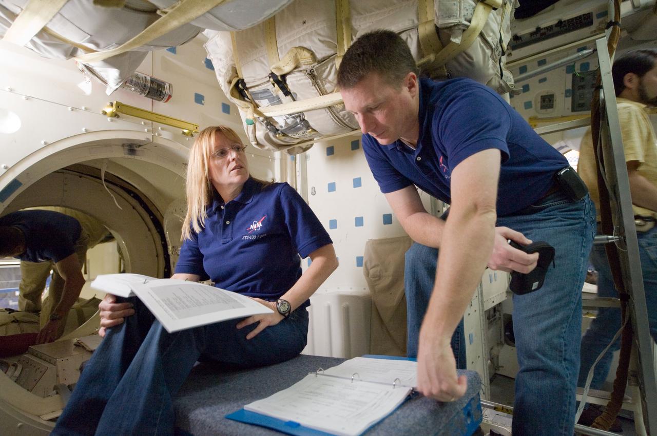 JSC2009-E-286950 (22 Dec. 2009) --- Astronauts Terry Virts, STS-130 pilot; and Kathryn Hire, mission specialist, participate in an ingress/egress timeline training session in a shuttle mock-up in the Space Vehicle Mock-up Facility at NASA's Johnson Space Center.