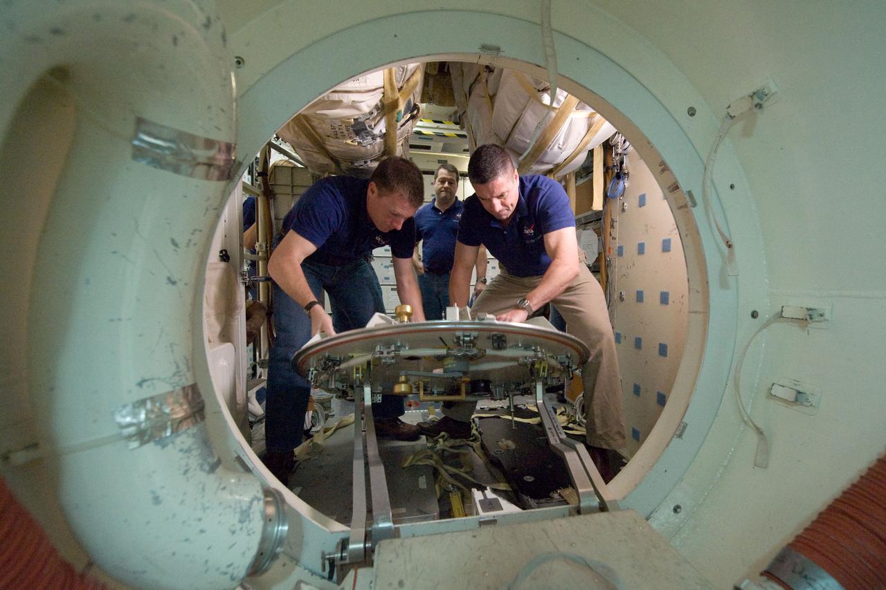 JSC2009-E-286956 (22 Dec. 2009) --- Astronauts George Zamka (right), STS-130 commander; Terry Virts, pilot; and Nicholas Patrick (background), mission specialist, participate in an ingress/egress timeline training session in a shuttle mock-up in the Space Vehicle Mock-up Facility at NASA's Johnson Space Center.