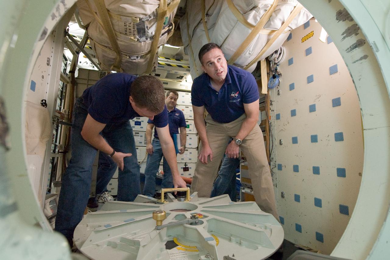 JSC2009-E-286958 (22 Dec. 2009) --- Astronauts George Zamka (right), STS-130 commander; Terry Virts, pilot; and Nicholas Patrick (background), mission specialist, participate in an ingress/egress timeline training session in a shuttle mock-up in the Space Vehicle Mock-up Facility at NASA's Johnson Space Center.