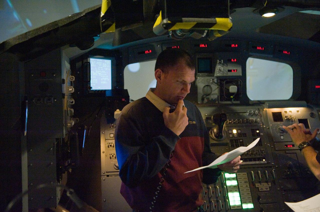 JSC2009-E-286960 (22 Dec. 2009) --- Astronaut Tony Antonelli, STS-132 pilot, uses a communication system during an exercise in the systems engineering simulator in the Avionics Systems Laboratory at NASA?s Johnson Space Center. The facility includes moving scenes of full-sized International Space Station components over a simulated Earth.