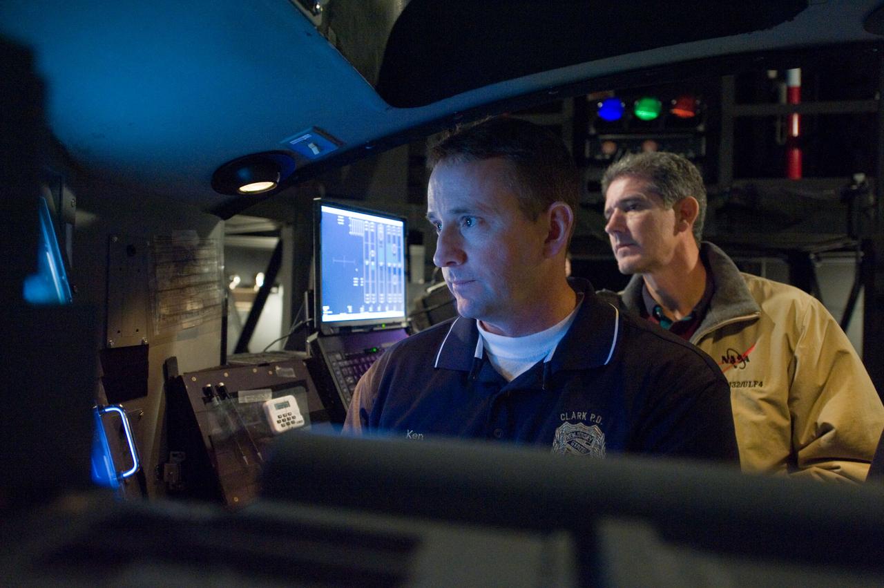 JSC2009-E-286964 (22 Dec. 2009) --- Astronauts Ken Ham (foreground), STS-132 commander; and Mike Good, mission specialist, participate in an exercise in the systems engineering simulator in the Avionics Systems Laboratory at NASA?s Johnson Space Center. The facility includes moving scenes of full-sized International Space Station components over a simulated Earth.