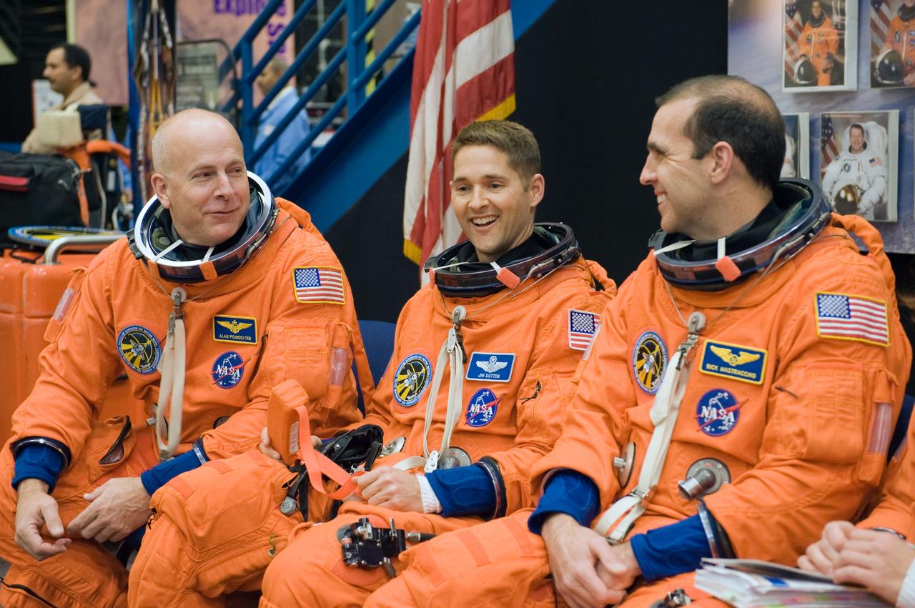 JSC2009-E-287972 (9 Dec. 2009) --- Attired in training versions of their shuttle launch and entry suits, NASA astronauts Alan Poindexter (left), STS-131 commander; James P. Dutton Jr. (center), pilot; and Rick Mastracchio, mission specialist, await the start of a training session in the Space Vehicle Mock-up Facility at NASA's Johnson Space Center.