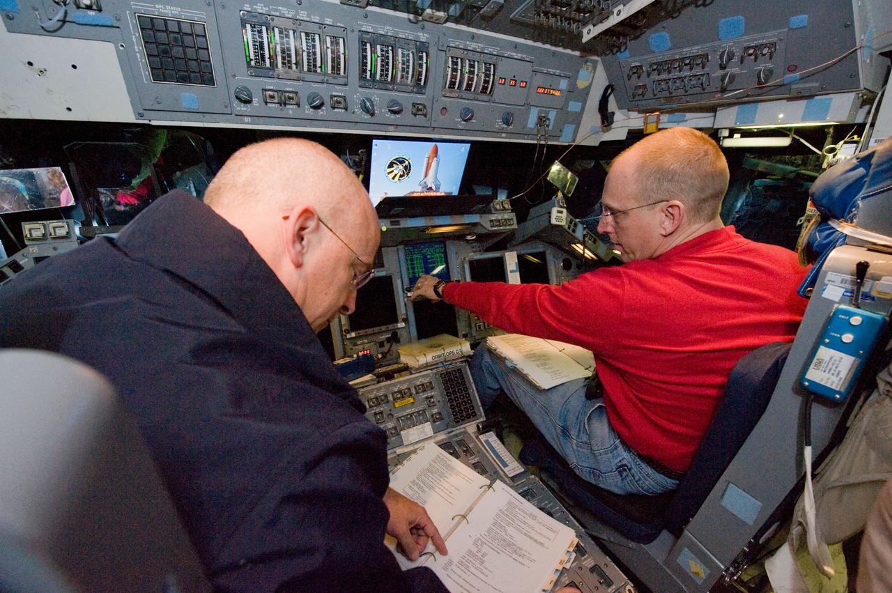 JSC2010-E-006693 (5 Jan. 2010) --- NASA astronauts Alan Poindexter (left), STS-131 commander; and Clayton Anderson, mission specialist, participate in an undocking timeline training session in the Guidance and Navigation Simulator in the Mission Simulation Development Facility at NASA's Johnson Space Center.