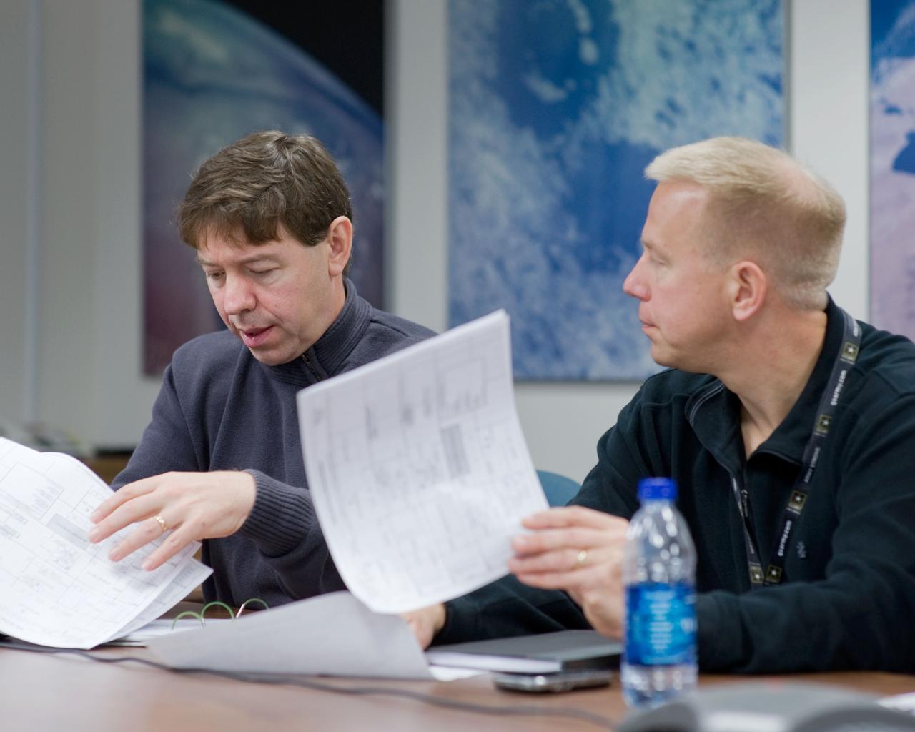JSC2010-E-006723 (5 Jan. 2010) --- NASA astronauts Michael Barratt (left) and Tim Kopra, both STS-133 mission specialists, are pictured during a training scheduling session at NASA?s Johnson Space Center.