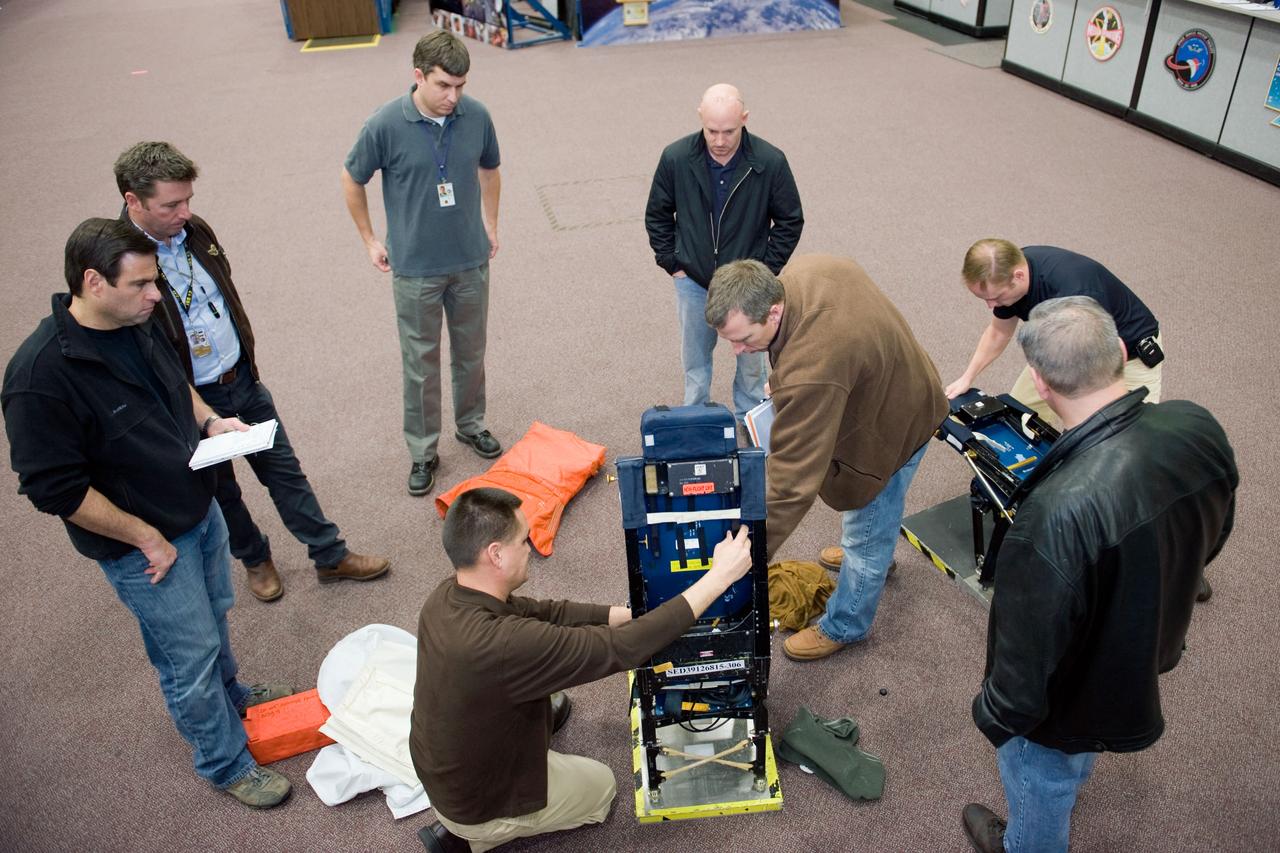 JSC2010-E-009595 (13 Jan. 2010) --- STS-134 crew members participate in a training session in the Space Vehicle Mock-up Facility at NASA?s Johnson Space Center. Pictured are NASA astronauts Mark Kelly (center right background), commander; Gregory H. Johnson (right foreground), pilot; Greg Chamitoff (left), Andrew Feustel (center right), Michael Fincke (right background) and European Space Agency astronaut Roberto Vittori (second left), all mission specialists. Crew trainer Adam Flagan (center foreground) assisted the crew members.