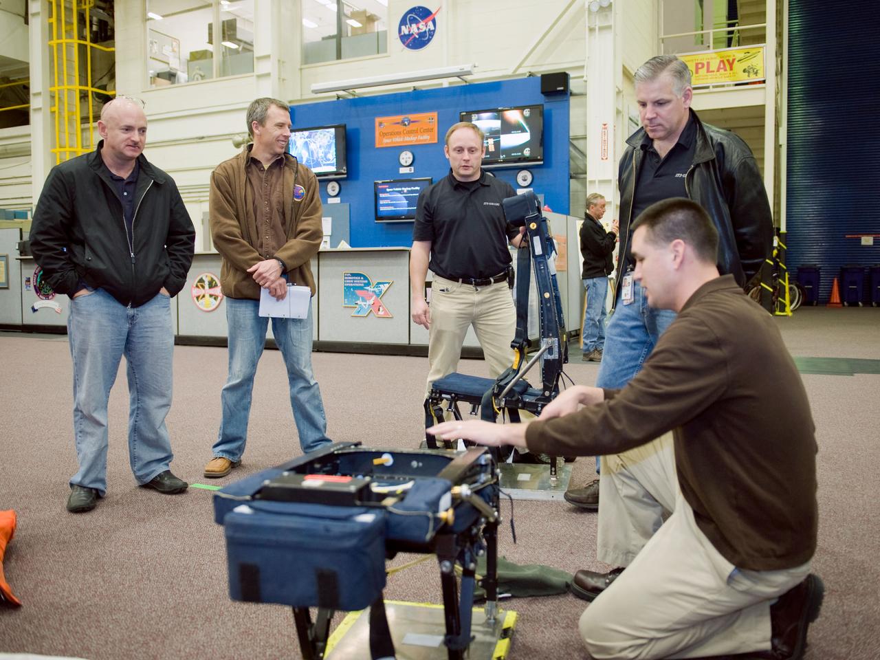 JSC2010-E-009597 (13 Jan. 2010) --- STS-134 crew members participate in a training session in the Space Vehicle Mock-up Facility at NASA?s Johnson Space Center. Pictured from the left are NASA astronauts Mark Kelly, commander; Andrew Feustel, Michael Fincke, both mission specialists; and Gregory H. Johnson, pilot. Crew trainer Adam Flagan assisted the crew members.