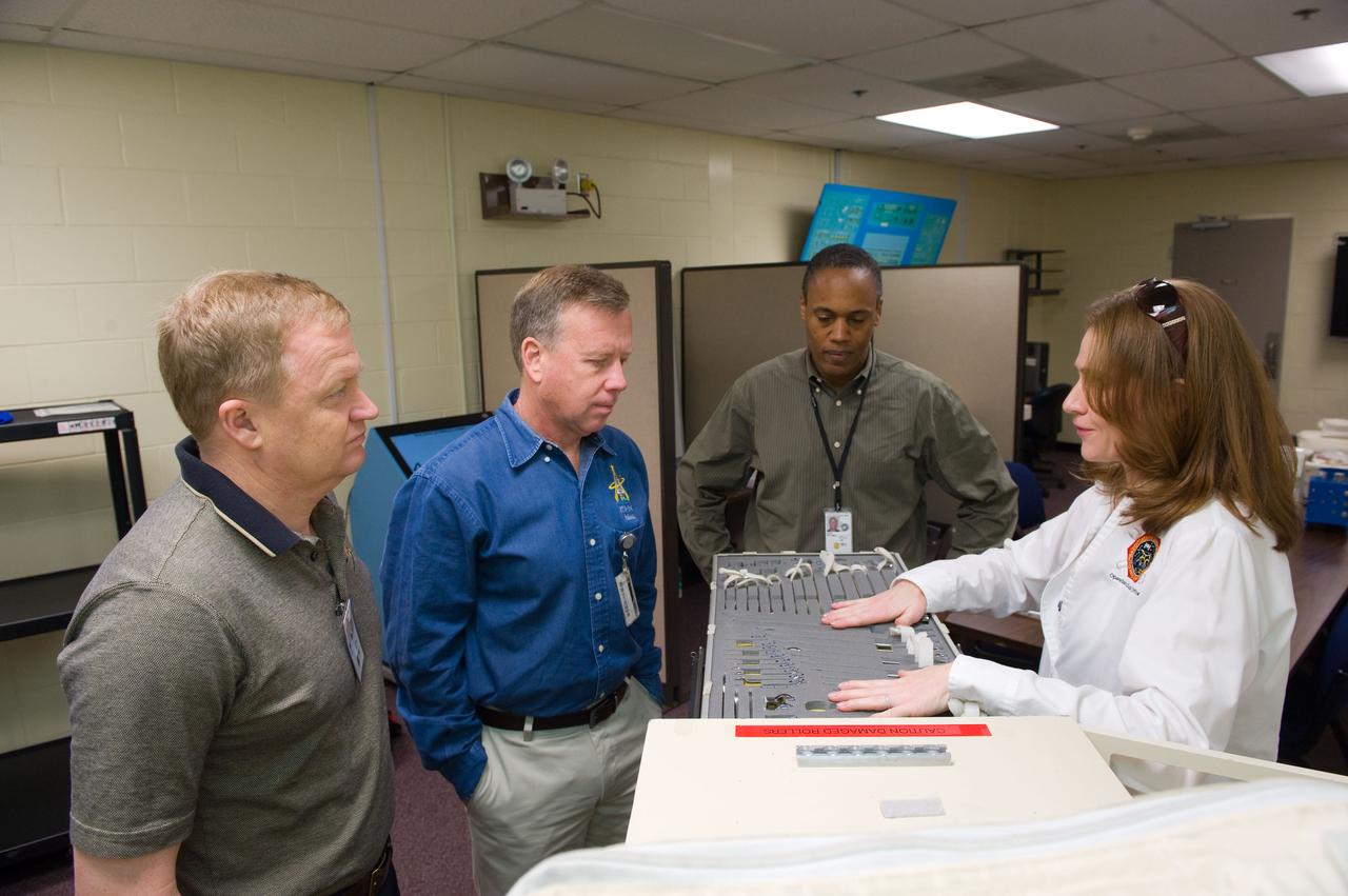 JSC2010-E-014262 (26 Jan. 2010) --- NASA astronauts Eric Boe (left), STS-133 pilot; Steve Lindsey, commander; and Alvin Drew, mission specialist, participate in an ISS tools and repair kits training session in the Space Vehicle Mock-up Facility at NASA's Johnson Space Center. Instructor Ivy Apostolakopoulos assisted the crew members.