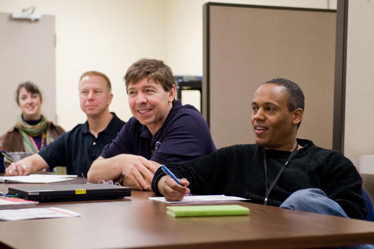 JSC2010-E-014658 (27 Jan. 2010) --- NASA astronauts Alvin Drew (right), Michael Barratt (center) and Tim Kopra, all STS-133 mission specialists, participate in a training session in the Space Vehicle Mock-up Facility at NASA's Johnson Space Center.