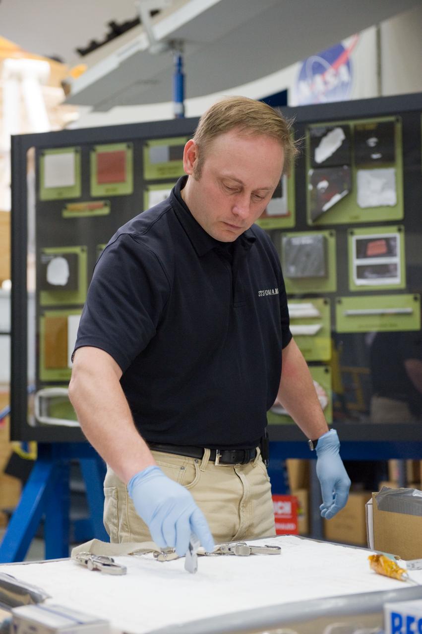 JSC2010-E-014767 (28 Jan. 2010) --- NASA astronaut Michael Fincke, STS-134 mission specialist, participates in an EVA tile repair training session in the Space Vehicle Mock-up Facility at NASA's Johnson Space Center.