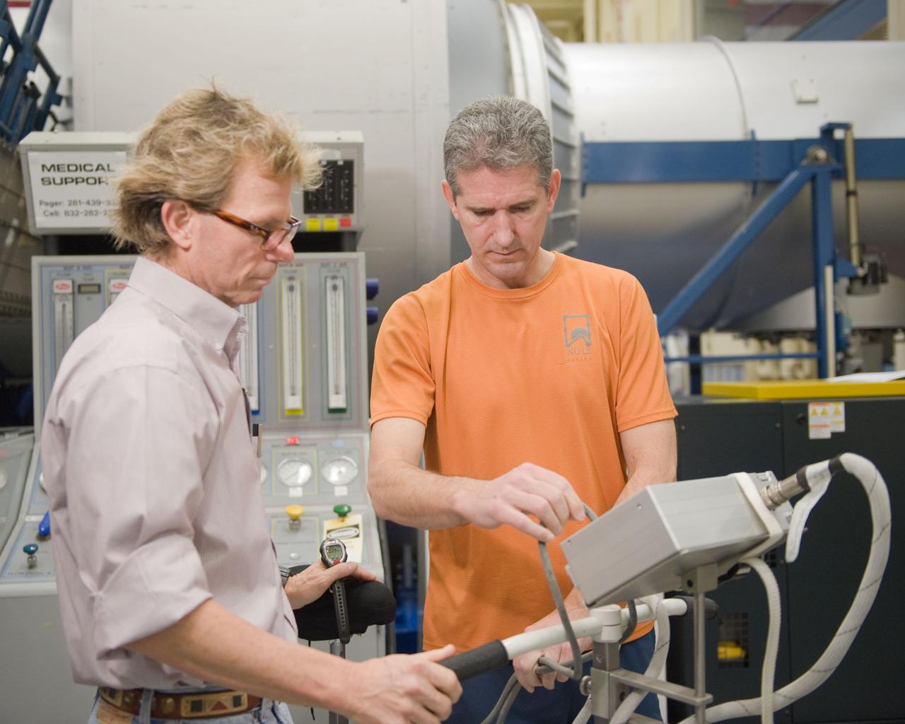 JSC2010-E-015337 (27 Jan. 2010) --- NASA astronaut Michael Good (right), STS-132 mission specialist, participates in a training session in the Space Vehicle Mock-up Facility at NASA's Johnson Space Center.