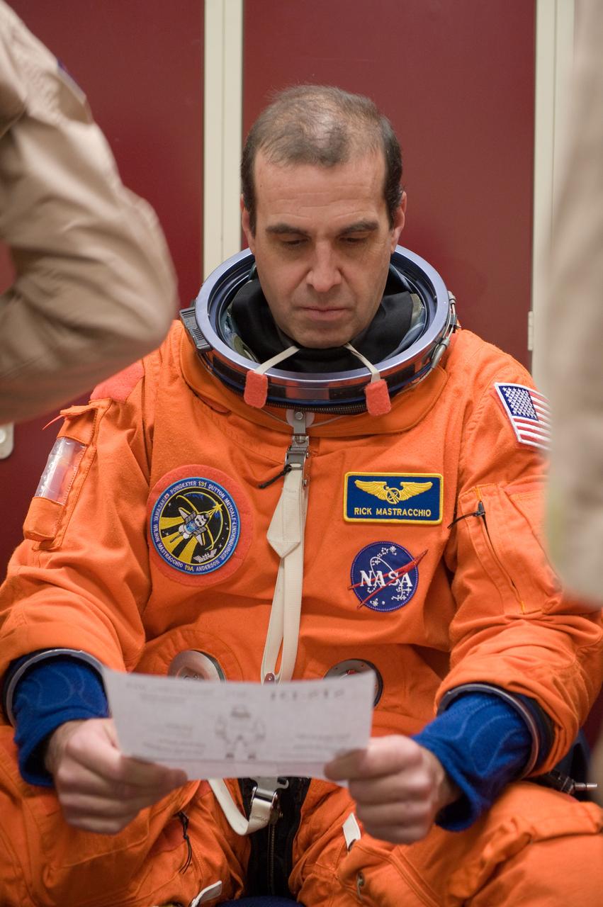 JSC2010-E-017715 (29 Jan. 2010) --- NASA astronaut Rick Mastracchio, STS-131 mission specialist, attired in a training version of his shuttle launch and entry suit, prepares for an ingress/egress training session in the Space Vehicle Mock-up Facility at NASA's Johnson Space Center.