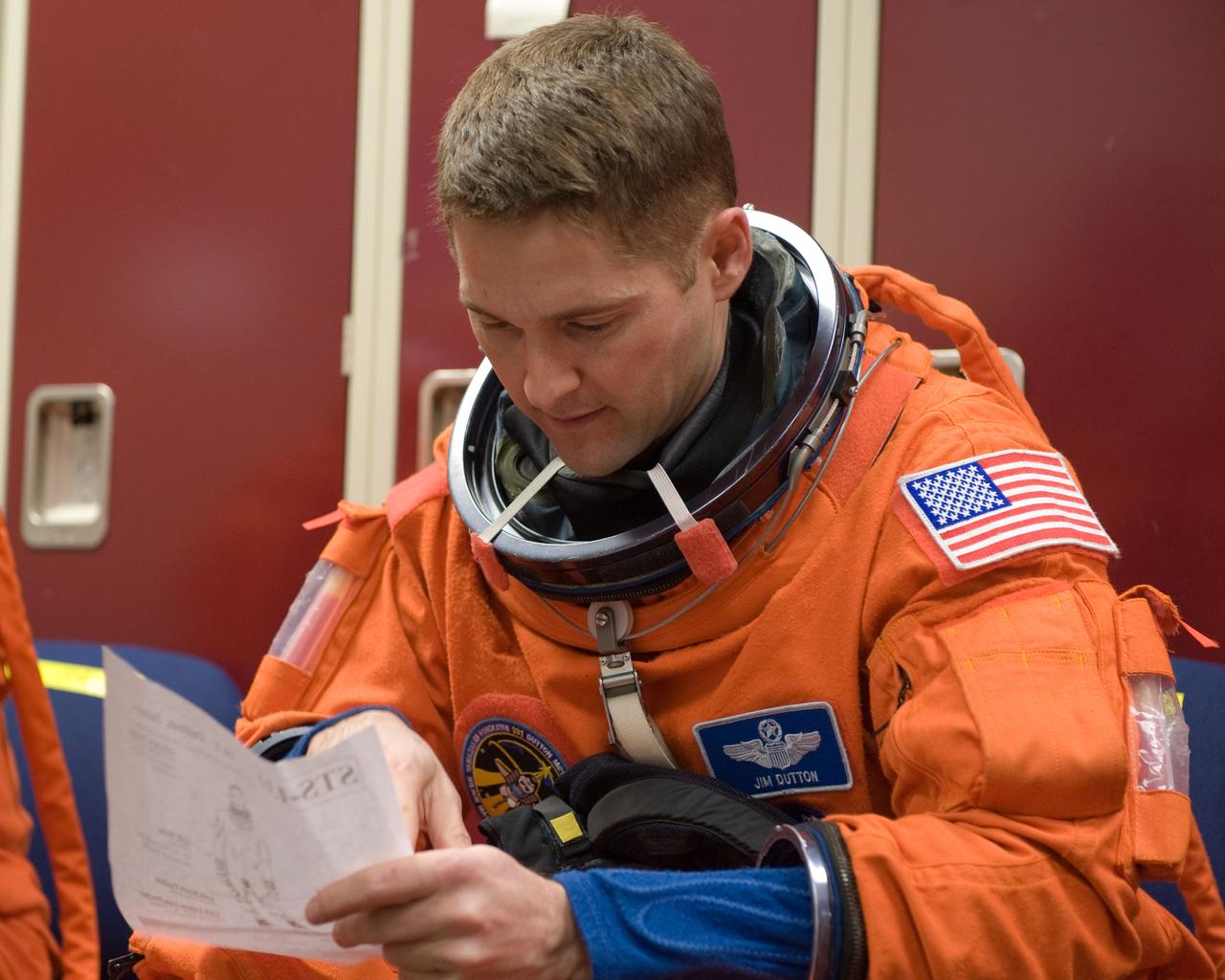 JSC2010-E-017718 (29 Jan. 2010) --- NASA astronaut James P. Dutton Jr., STS-131 pilot, attired in a training version of his shuttle launch and entry suit, prepares for an ingress/egress training session in the Space Vehicle Mock-up Facility at NASA's Johnson Space Center.