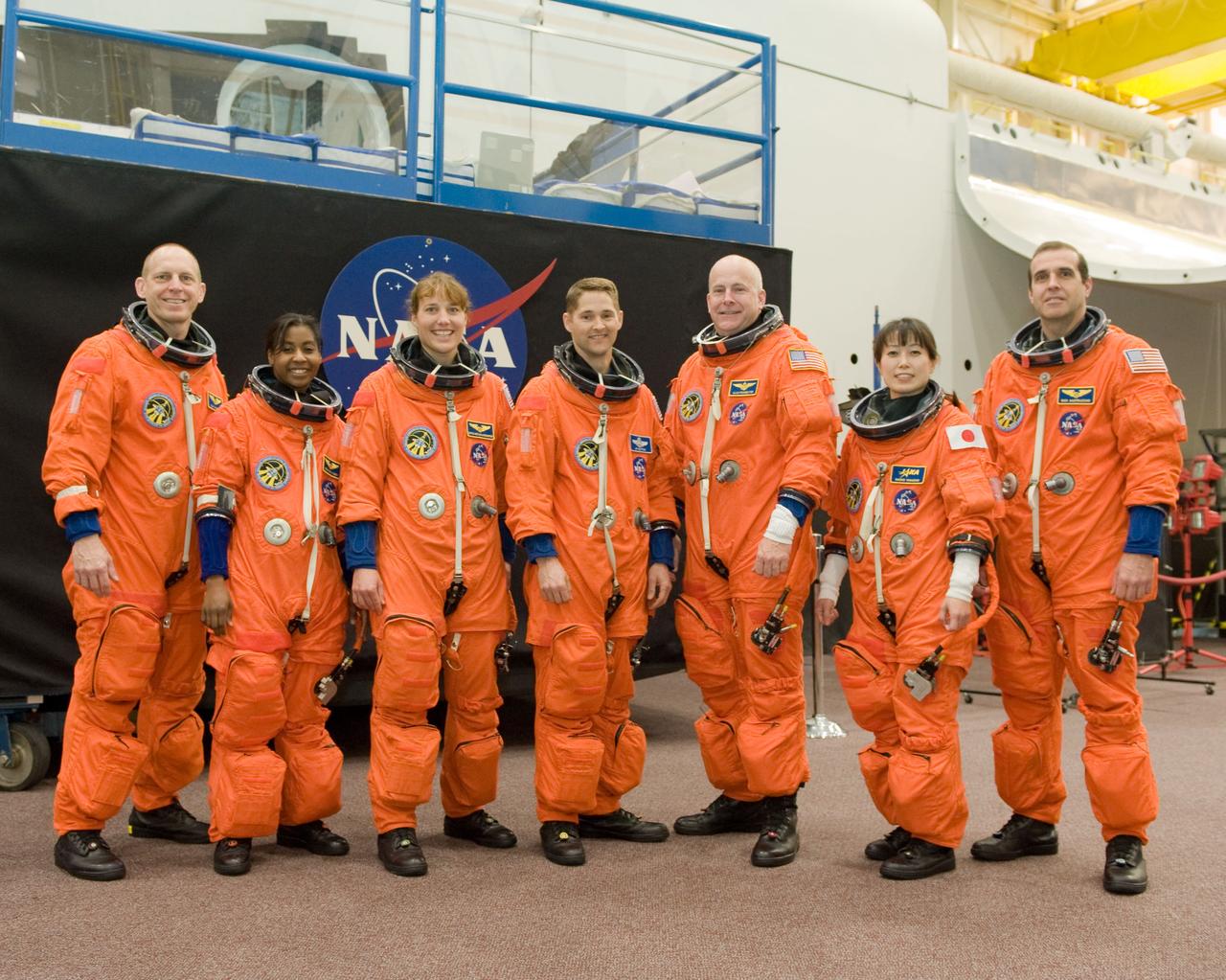JSC2010-E-017729 (29 Jan. 2010) --- Attired in training versions of their shuttle launch and entry suits, the STS-131 crew members take a break for a photo during a training session in the Space Vehicle Mock-up Facility at NASA's Johnson Space Center. From the left are NASA astronauts Clay Anderson, Stephanie Wilson, Dorothy Metcalf-Lindenburger, all mission specialists; James P. Dutton Jr., pilot; Alan Poindexter, commander; Japan Aerospace Exploration Agency (JAXA) astronaut Naoko Yamazaki and NASA astronaut Rick Mastracchio, both mission specialists.