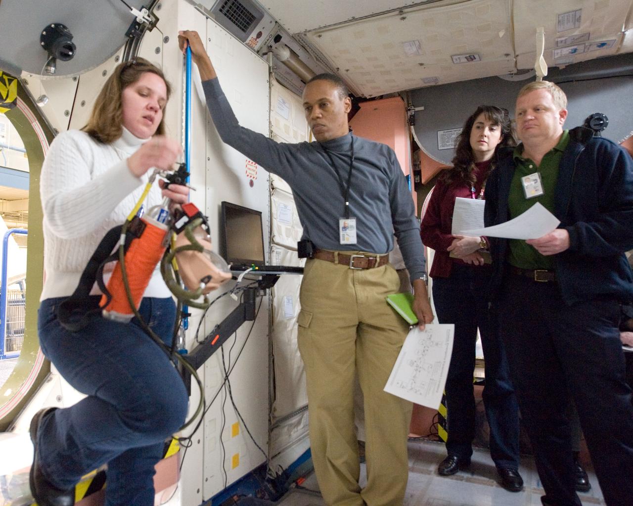 JSC2010-E-017947 (2 Feb. 2010) --- NASA astronauts Alvin Drew (second left), STS-133 mission specialist; and Eric Boe, pilot, participate in a training session in an International Space Station mock-up/trainer in the Space Vehicle Mock-up Facility at NASA's Johnson Space Center.