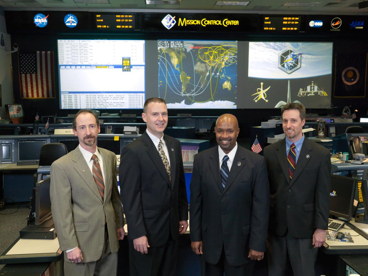 JSC2010-E-017954 (4 Feb. 2010) --- Flight directors for the STS-130/20A mission pose for a preflight group portrait in the space shuttle flight control room in the Mission Control Center at NASA's Johnson Space Center. Pictured from the left are Chris Edelen, Norm Knight, Kwatsi Alibaruho and Gary Horlacher.