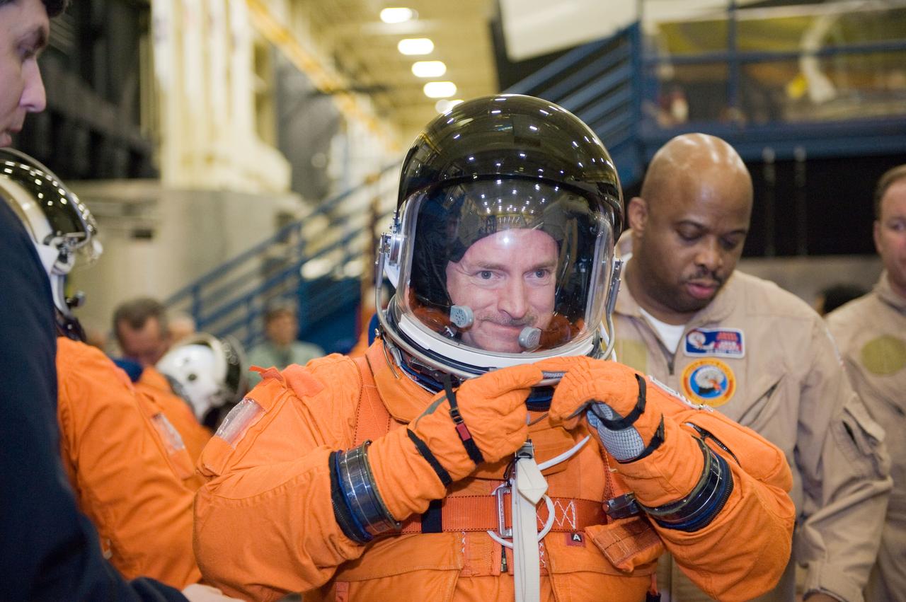 JSC2010-E-018505 (3 Feb. 2010) --- NASA astronaut Mark Kelly, STS-134 commander, dons a training version of his shuttle launch and entry suit in preparation for a training session in the Space Vehicle Mock-up Facility at NASA's Johnson Space Center.