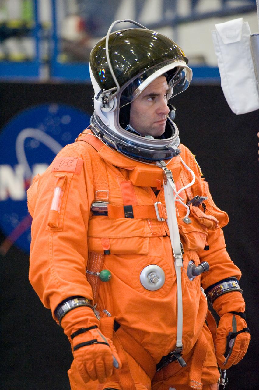 JSC2010-E-018547 (3 Feb. 2010) --- NASA astronaut Greg Chamitoff, STS-134 mission specialist, attired in a training version of his shuttle launch and entry suit, is pictured during a training session in the Space Vehicle Mock-up Facility at NASA's Johnson Space Center.