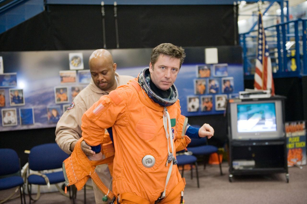 JSC2010-E-018581 (3 Feb. 2010) --- European Space Agency astronaut Roberto Vittori, STS-134 mission specialist, dons a training version of his shuttle launch and entry suit in preparation for a training session in the Space Vehicle Mock-up Facility at NASA?s Johnson Space Center. United Space Alliance suit technician Andre Denard assisted Vittori.