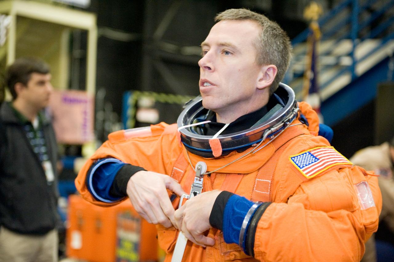 JSC2010-E-018595 (3 Feb. 2010) --- NASA astronaut Andrew Feustel, STS-134 mission specialist, dons a training version of his shuttle launch and entry suit in preparation for a training session in the Space Vehicle Mock-up Facility at NASA?s Johnson Space Center.
