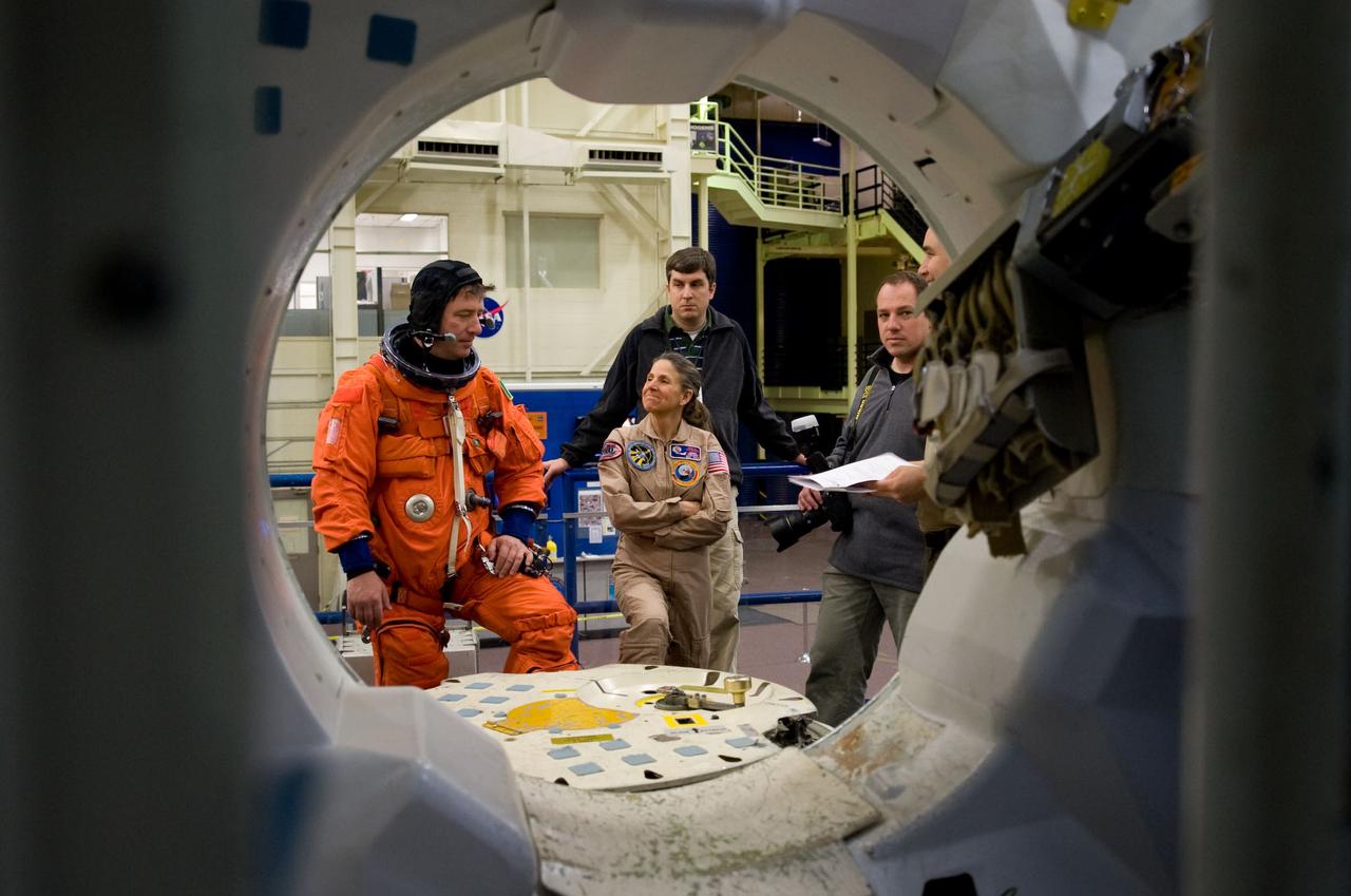JSC2010-E-018892 (3 Feb. 2010) --- European Space Agency astronaut Roberto Vittori (left), STS-134 mission specialist, attired in a training version of his shuttle launch and entry suit, is pictured during a training session in the Space Vehicle Mock-up Facility at NASA's Johnson Space Center.