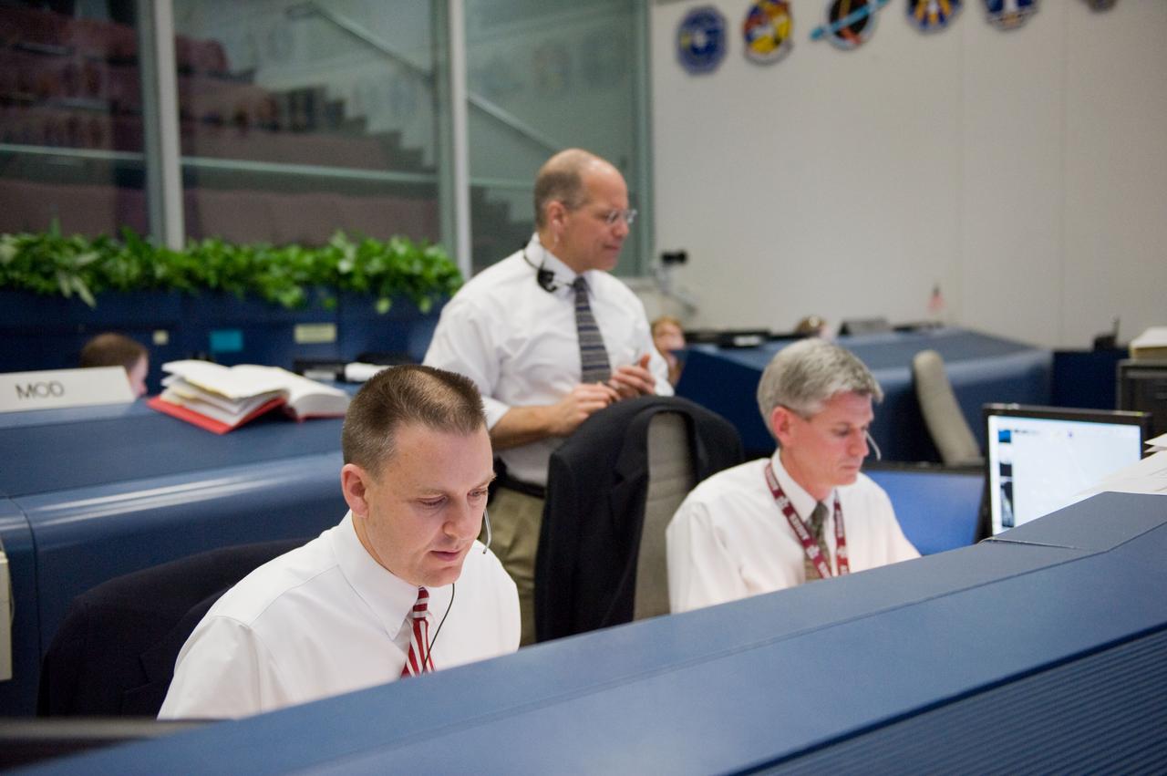 JSC2010-E-018923 (7 Feb. 2010) --- Flight directors Norm Knight (left), Bryan Lunney and Tony Ceccacci (standing) are pictured in the space shuttle flight control room in the Johnson Space Center's Mission Control Center as they anticipate the launch of STS-130. The launch attempt was later postponed until Feb. 8, due to weather conditions.