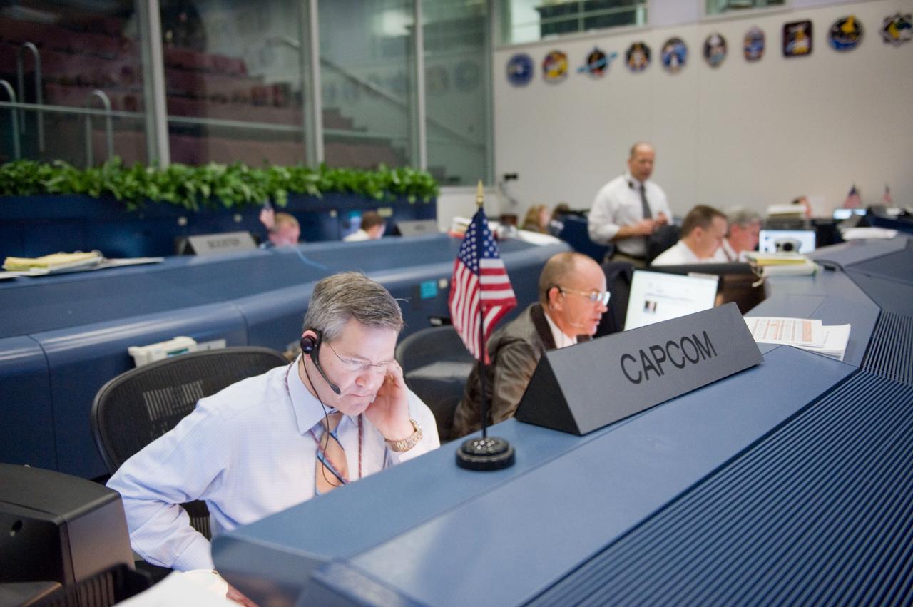 JSC2010-E-018924 (7 Feb. 2010) --- Astronauts Steve Frick (left) and Rick Sturckow, both STS-130 spacecraft communicators (CAPCOM), monitor data at their consoles in the space shuttle flight control room in the Johnson Space Center's Mission Control Center as they anticipate the launch of STS-130. The launch attempt was later postponed until Feb. 8, due to weather conditions.