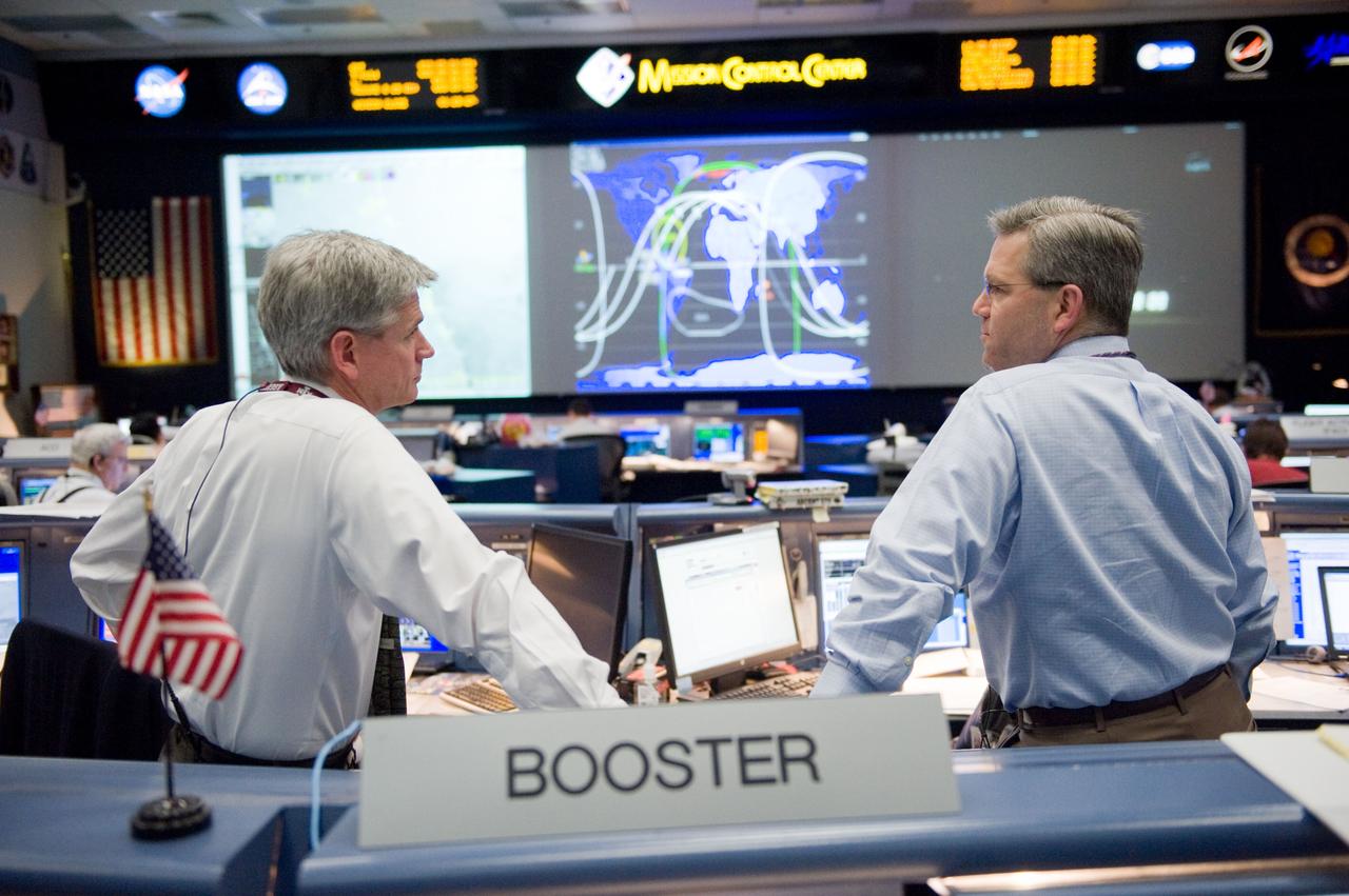 JSC2010-E-018926 (7 Feb. 2010) --- Flight director Bryan Lunney (left) and astronaut Steve Frick, STS-130 spacecraft communicator (CAPCOM), are pictured in the space shuttle flight control room in the Johnson Space Center's Mission Control Center as they anticipate the launch of STS-130. The launch attempt was later postponed until Feb. 8, due to weather conditions.