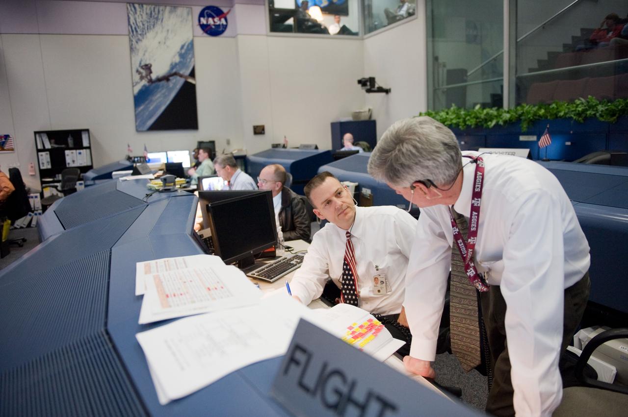 JSC2010-E-018935 (7 Feb. 2010) --- Flight directors Norm Knight (left) and Bryan Lunney are pictured at their consoles in the space shuttle flight control room in the Johnson Space Center's Mission Control Center during the first launch attempt of the STS-130 mission. The launch was postponed until Feb. 8, due to weather conditions.