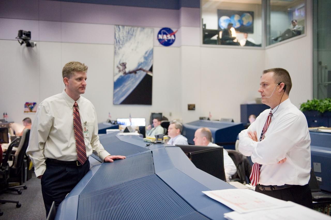 JSC2010-E-018949 (7 Feb. 2010) --- Flight director Norm Knight (right) and flight controller Mark McDonald are pictured in the space shuttle flight control room in the Johnson Space Center's Mission Control Center during the first launch attempt of the STS-130 mission. The launch was postponed until Feb. 8, due to weather conditions.