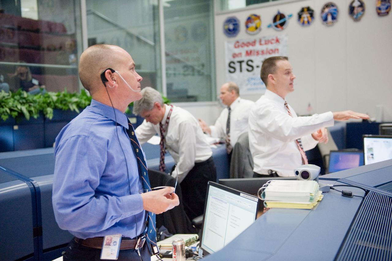 JSC2010-E-019017 (8 Feb. 2010) --- Astronaut Rick Sturckow (left), STS-130 spacecraft communicator (CAPCOM); and flight director Norm Knight are pictured at their consoles in the space shuttle flight control room in the Johnson Space Center's Mission Control Center during launch countdown activities a few hundred miles away in Florida, site of space shuttle Endeavour's STS-130 launch. Flight directors Bryan Lunney (left) and Tony Ceccacci are visible in the background.