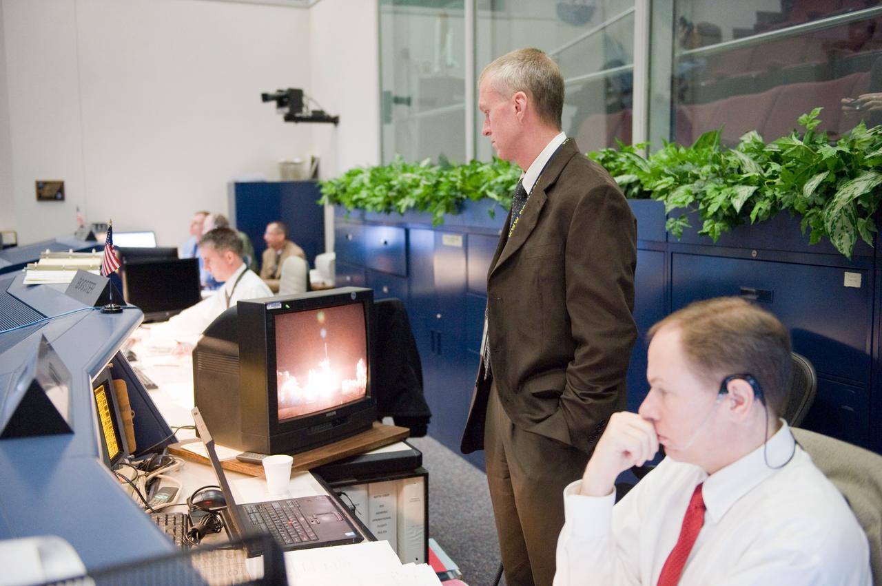 JSC2010-E-019040 (8 Feb. 2010) --- Brent Jett, director, flight crew operations, watches a monitor at his console in the space shuttle flight control room in the Mission Control Center at NASA's Johnson Space Center during launch countdown activities a few hundred miles away in Florida, site of space shuttle Endeavour's STS-130 launch. John McCullough (seated), chief of the flight director office, is at right.