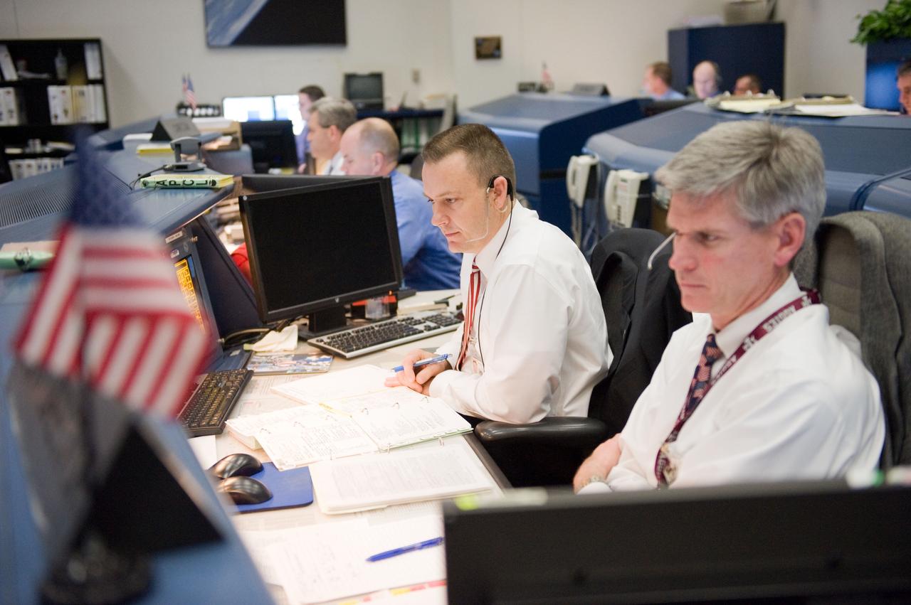 JSC2010-E-019041 (8 Feb. 2010) --- Flight directors Norm Knight (left) and Bryan Lunney monitor data at their console in the space shuttle flight control room in the Mission Control Center at NASA's Johnson Space Center during launch countdown activities a few hundred miles away in Florida, site of space shuttle Endeavour's STS-130 launch.