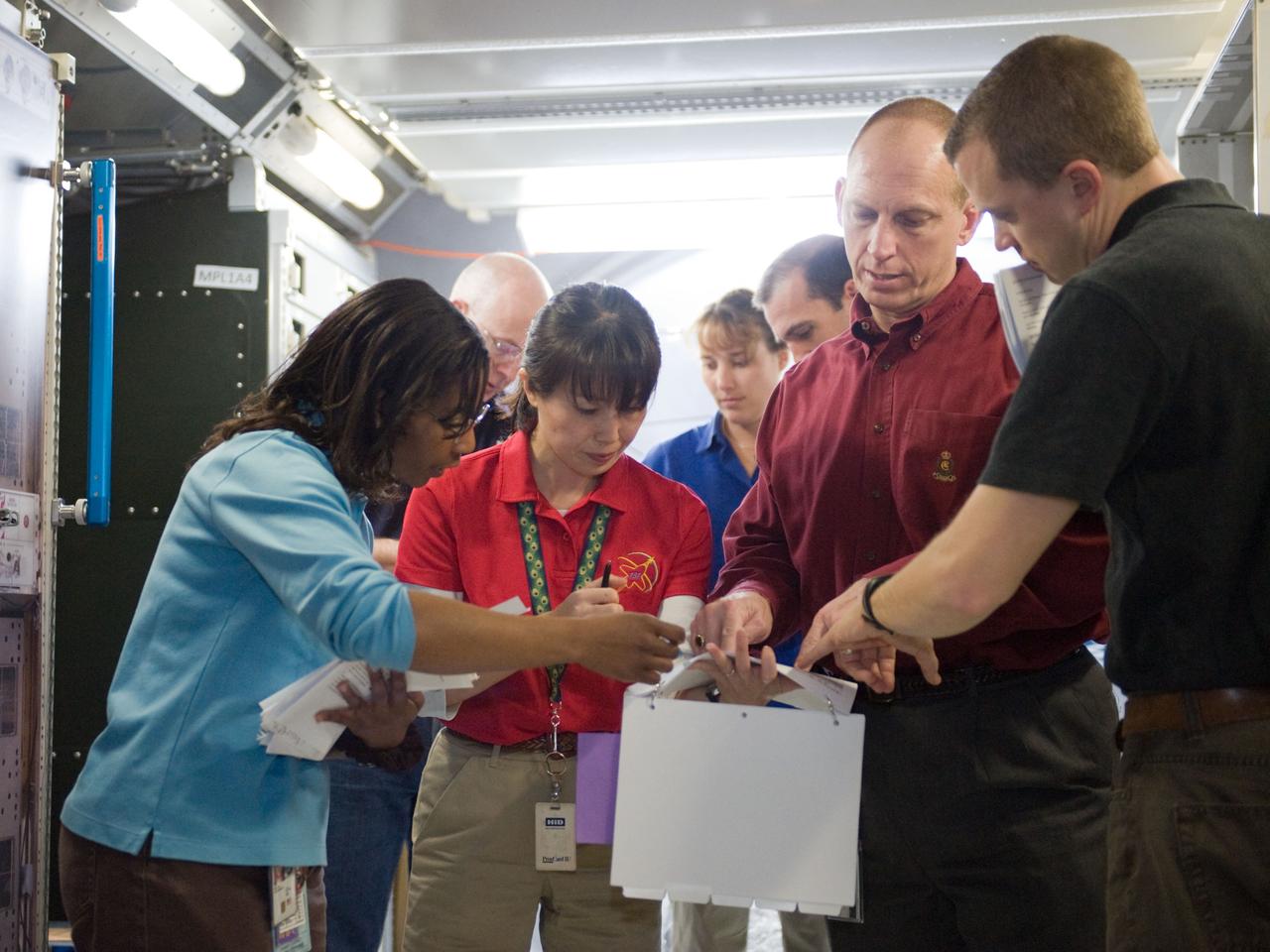 JSC2010-E-019461 (8 Feb. 2010) --- STS-131 crew members participate in a training session in an International Space Station mock-up/trainer in the Space Vehicle Mock-up Facility at NASA's Johnson Space Center. Pictured from the left (foreground) are NASA astronaut Stephanie Wilson, Japan Aerospace Exploration Agency (JAXA) astronaut Naoko Yamazaki and NASA astronaut Clayton Anderson, all mission specialists. Pictured from the left (background) are NASA astronauts Alan Poindexter, commander; along with Dorothy Metcalf-Lindenburger and Rick Mastracchio, both mission specialists. Instructor Jeremy Owen (right foreground) assisted the crew members. Not pictured is NASA astronaut James P. Dutton Jr., pilot.