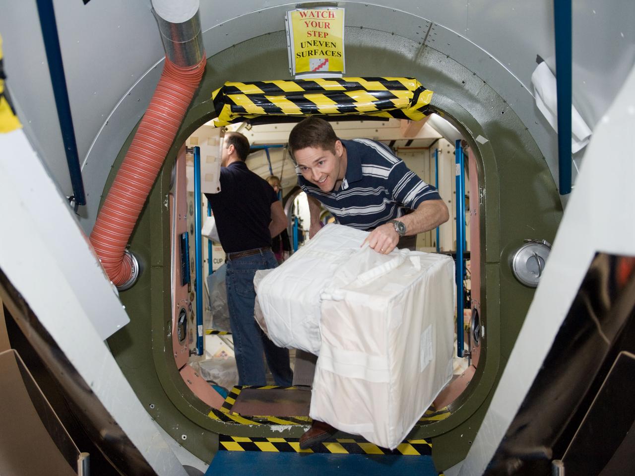 JSC2010-E-019468 (8 Feb. 2010) --- NASA astronaut James P. Dutton Jr., STS-131 pilot, participates in a training session in an International Space Station mock-up/trainer in the Space Vehicle Mock-up Facility at NASA's Johnson Space Center.