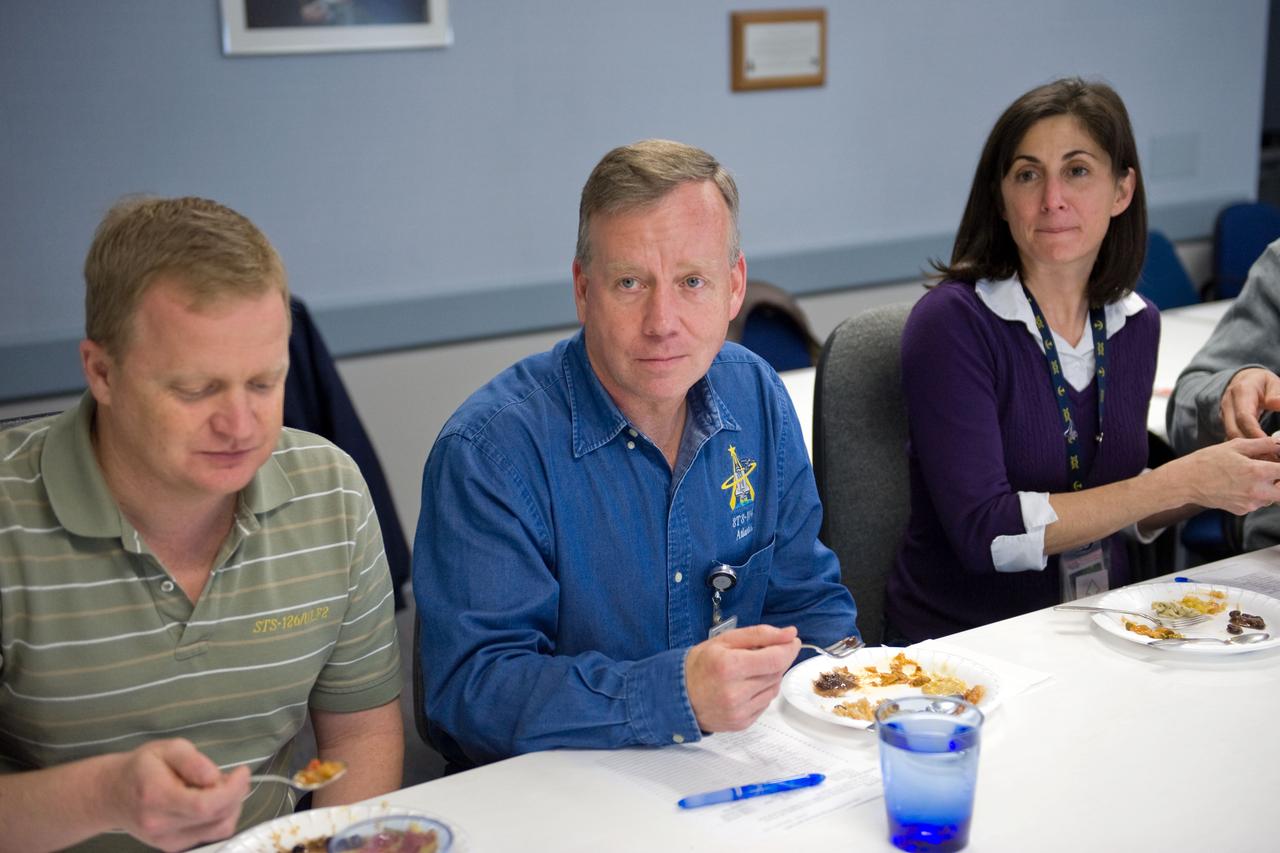 JSC2010-E-020620 (9 Feb. 2010) --- NASA astronauts Steve Lindsey (center), STS-133 commander; Eric Boe, pilot; and Nicole Stott, mission specialist, are pictured during a food tasting session in the Habitability and Environmental Factors Office at NASA's Johnson Space Center.
