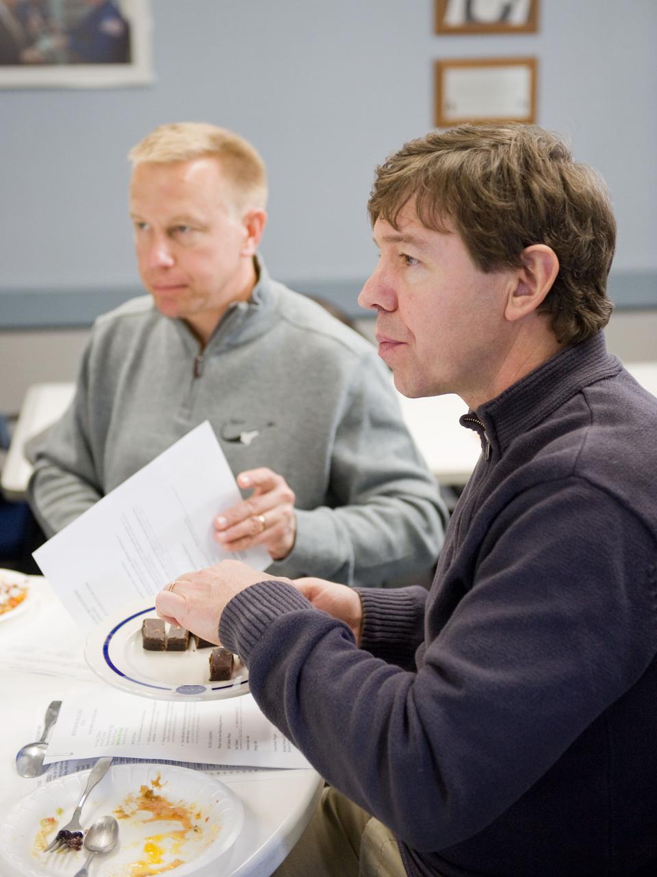 JSC2010-E-020628 (9 Feb. 2010) --- NASA astronauts Michael Barratt (right) and Tim Kopra, both STS-133 mission specialists, are pictured during a food tasting session in the Habitability and Environmental Factors Office at NASA's Johnson Space Center.