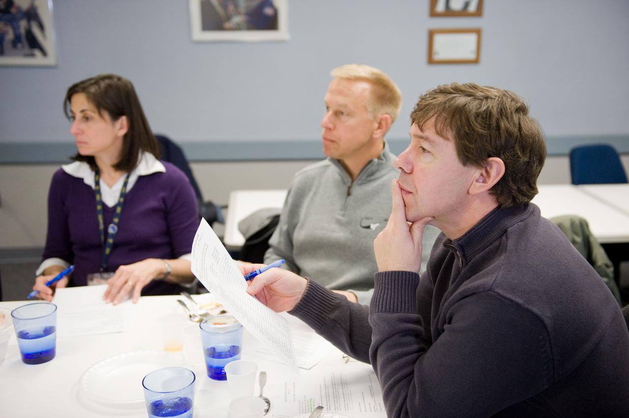 JSC2010-E-020630 (9 Feb. 2010) --- NASA astronaut Nicole Stott, Tim Kopra (center) and Michael Barratt, all STS-133 mission specialists, are pictured during a food tasting session in the Habitability and Environmental Factors Office at NASA's Johnson Space Center.