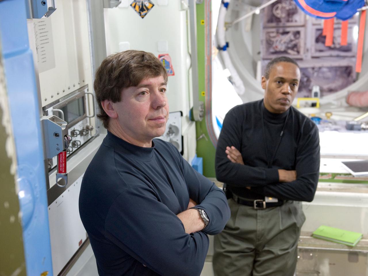 JSC2010-E-020701 (10 Feb. 2010) --- NASA astronauts Michael Barratt (foreground) and Alvin Drew, both STS-133 mission specialists, participate in a training session in an International Space Station mock-up/trainer in the Space Vehicle Mock-up Facility at NASA's Johnson Space Center.